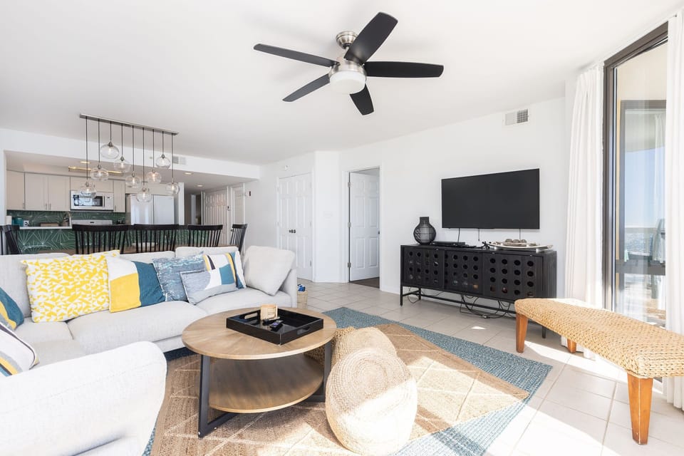 Contemporary open floor plan with natural light, coastal-inspired accents, and direct access to the kitchen and dining area