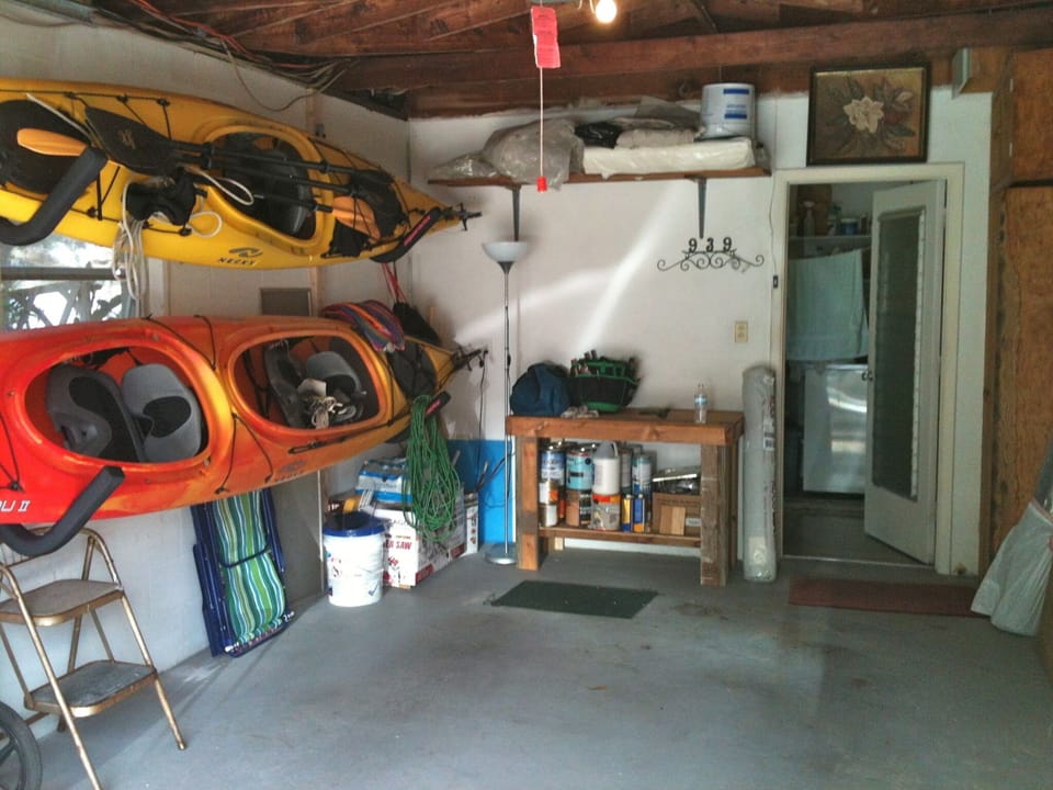 One-car garage with kayaks and bikes.
Kayak paddles are in the shed by the water