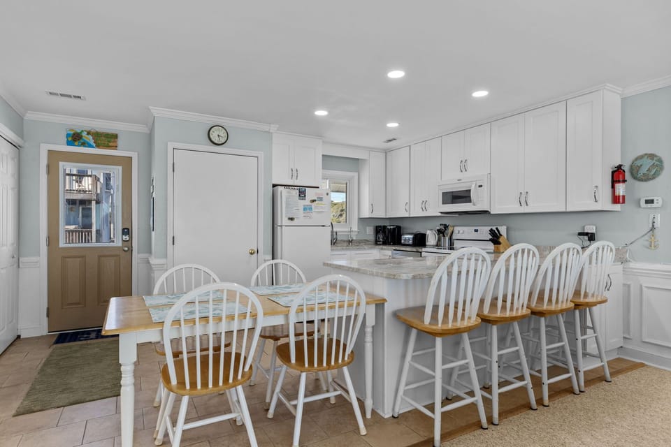 Your bright, open kitchen features a spacious island with bar seating, perfect for morning coffee or casual meals together.