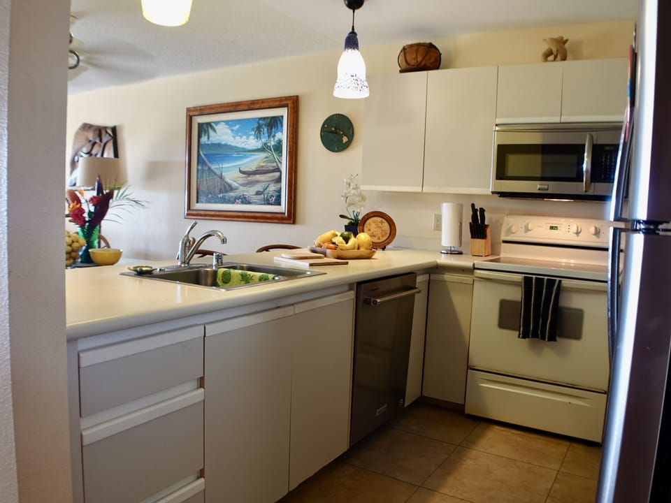 Spacious kitchen with counter looking out at the ocean. 