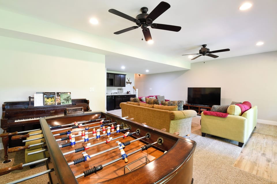 Basement Recroom: Foosball, 70" smart TV with Dish Network, wet bar, piano