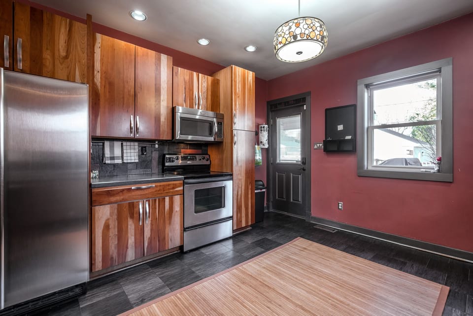 Kitchen with electric range and access to the deck and garage