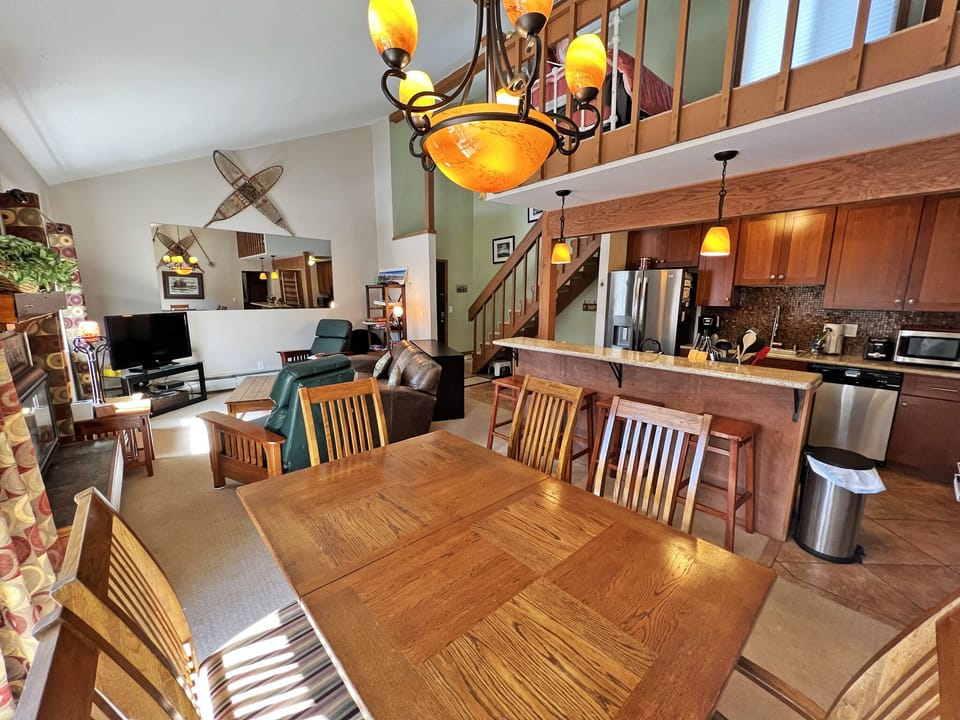 Kitchen and dining room with open floor plan and door to deck.