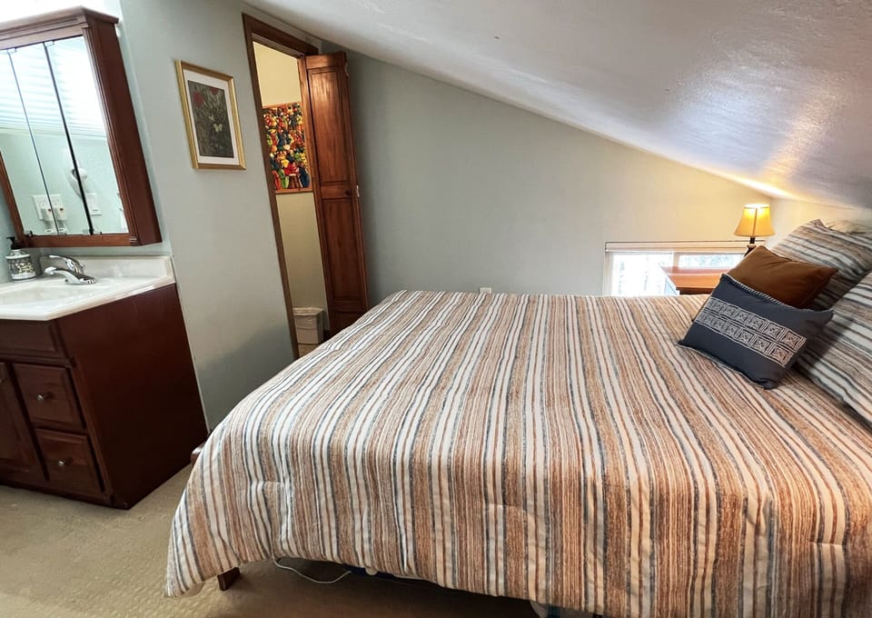 Upstairs bedroom with half bath.