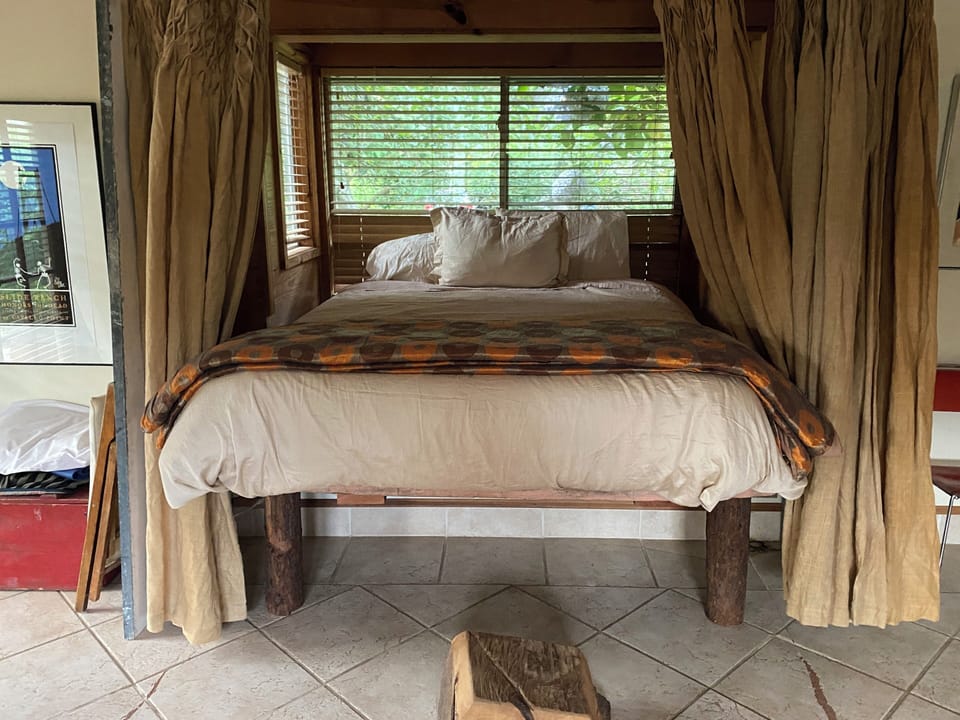 Queen bed with privacy curtain.