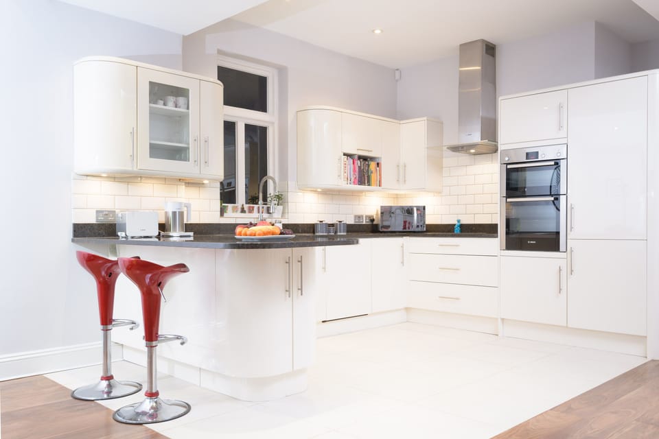 Modern open plan kitchen with Bosch appliances including double oven