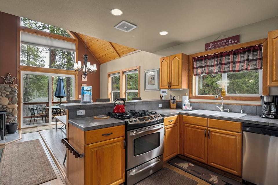 Your fully-equipped kitchen features warm wood cabinets, granite counters, and stainless appliances, perfect for creating memorable meals together.