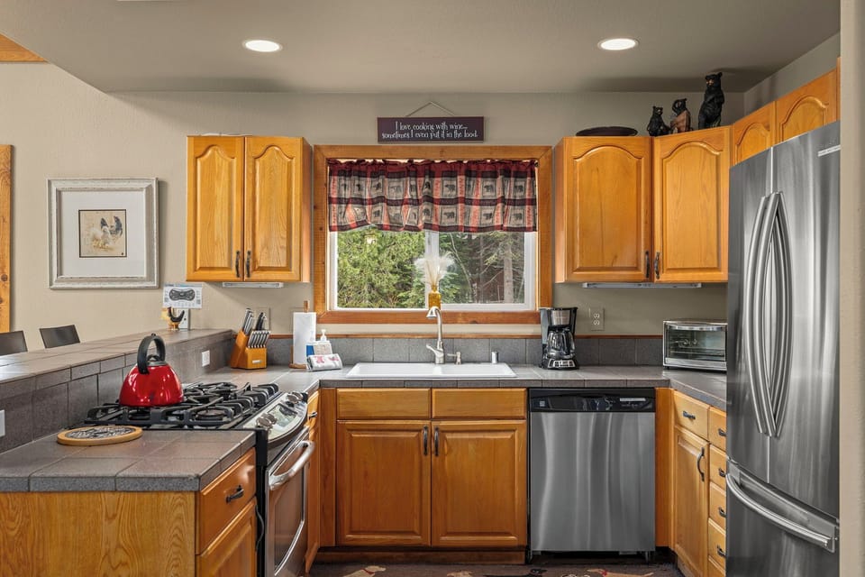 Your fully equipped kitchen awaits with gleaming stainless appliances, granite counters, and everything you need for home-cooked meals.