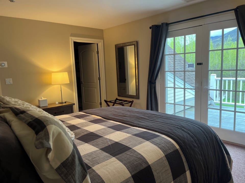French doors to balcony overlooking backyard with views of Mt. Equinox