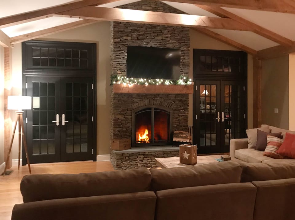 Stacked-stone fireplace and french doors.