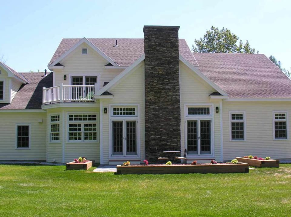 Bluestone patio with oversized outdoor dining set and stainless Weber grill. 