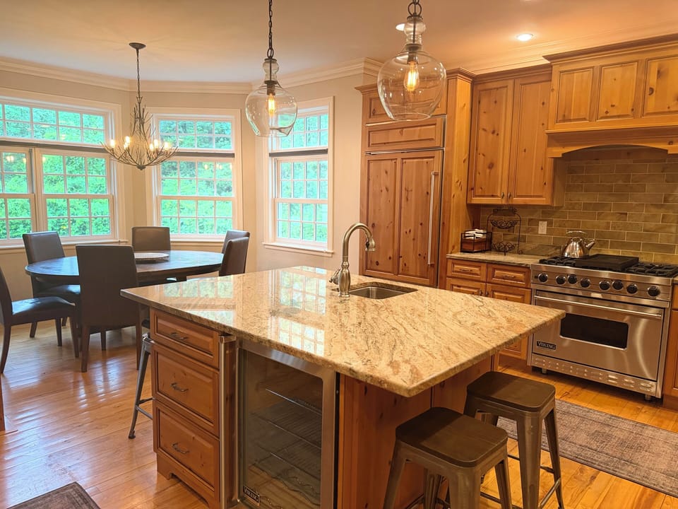Open kitchen with Viking range/oven, Sub Zero & wine fridges, and lovely views