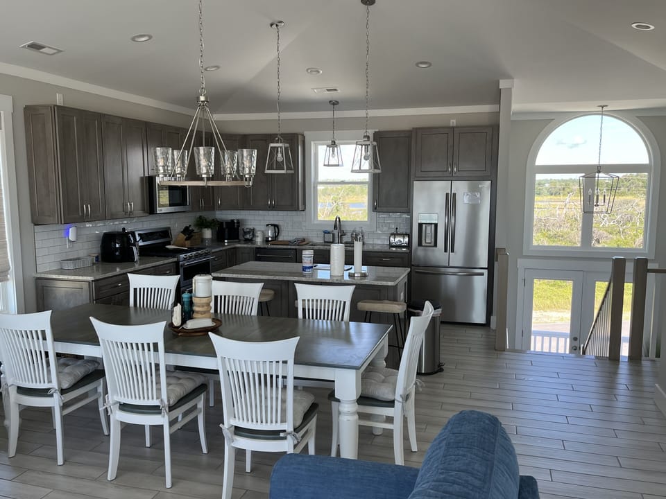 Open dining and kitchen areas offering an inland waterway view.  Dining  for 12