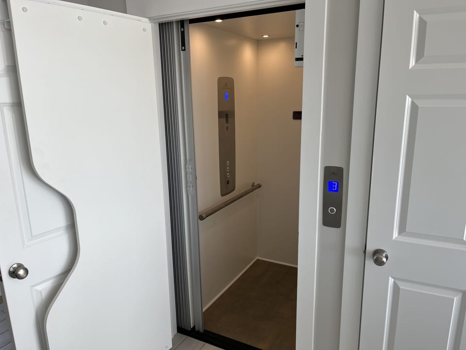 Elevator safety bar and control panel.