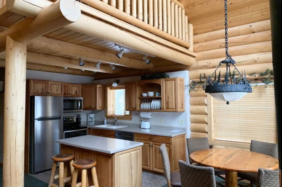 Fully equipped kitchen with essentials, including a refrigerator, stove, oven, microwave, and dishwasher.