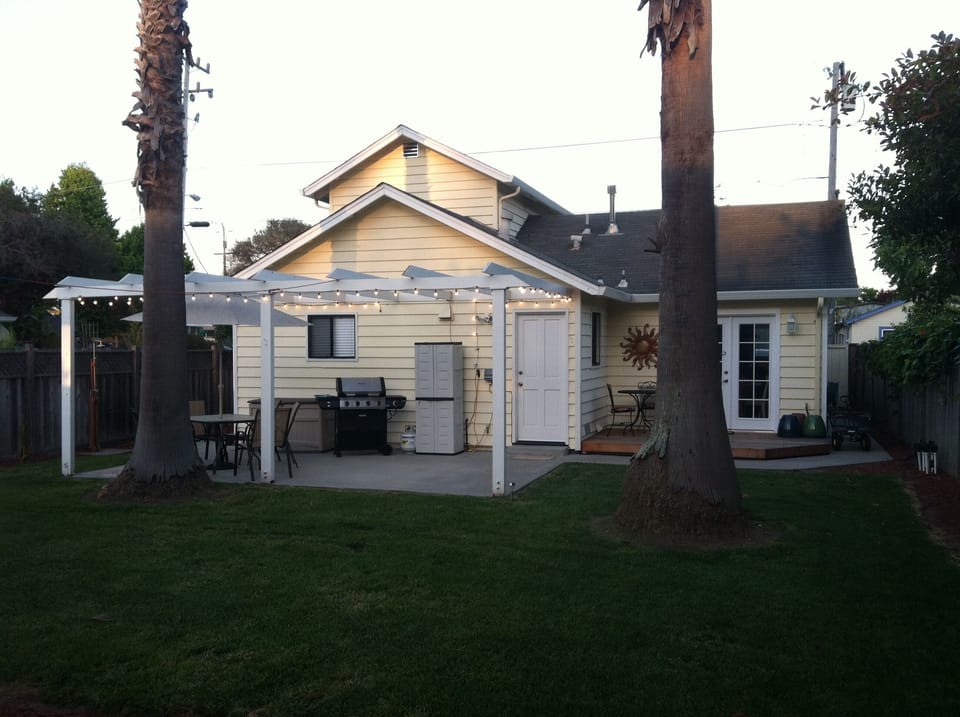 Private backyard with redwood deck, gas grill and large patio and grass area