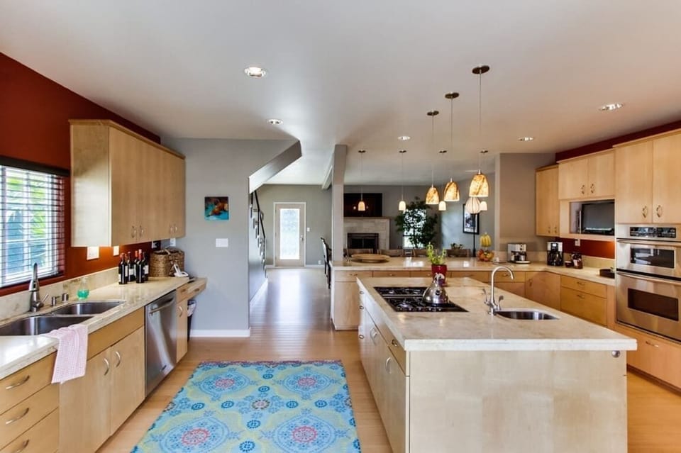 Kitchen with stainless steel appliances, coffee maker, blender, recessed lighting, toaster, blender, and a gas stove