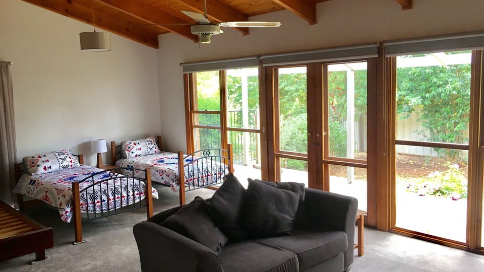 Children’s Zone with 2 king singles and a single bed , couch and tv