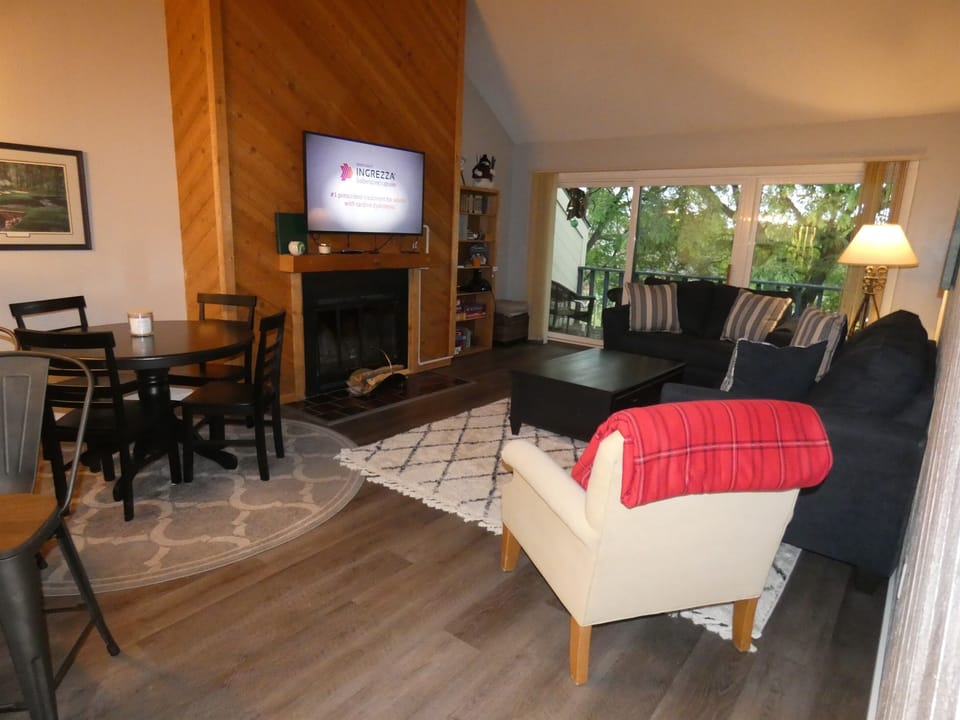 Living area with wood fireplace and tv.