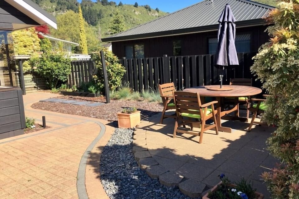 Sunny paved courtyard and  garden