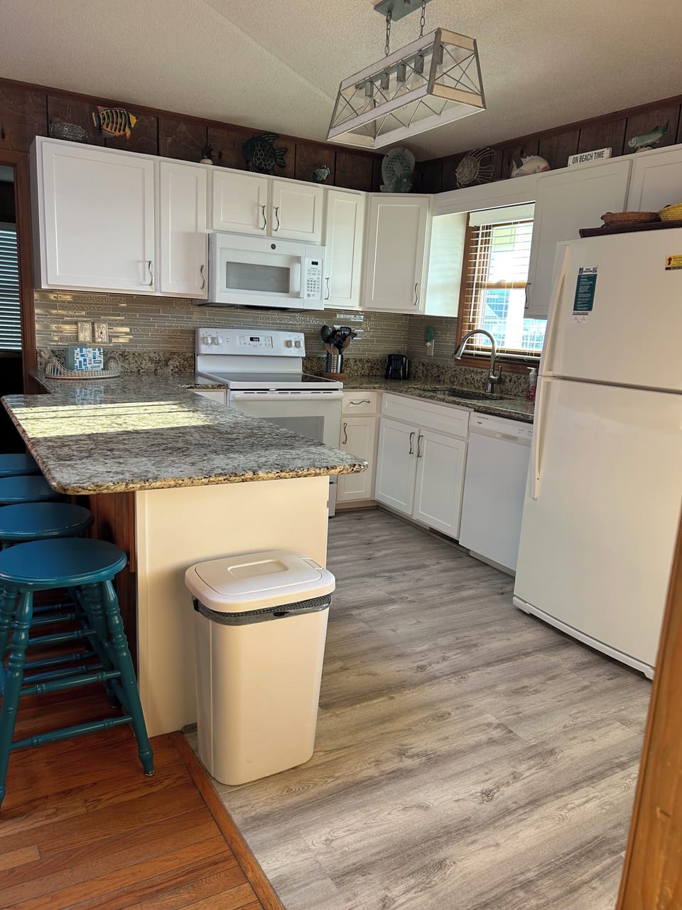 Granite counter tops and bar stools for four.