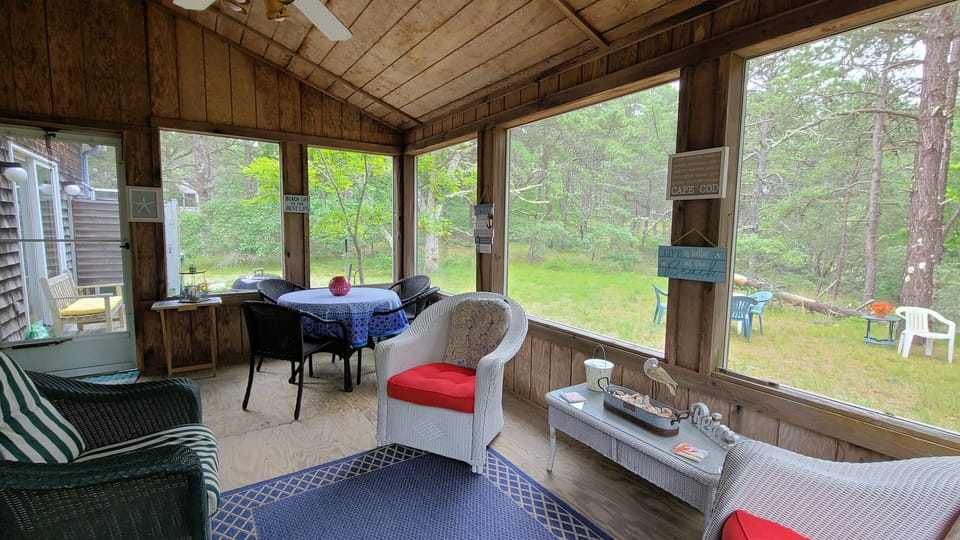 Screen porch with dining table and additional seating