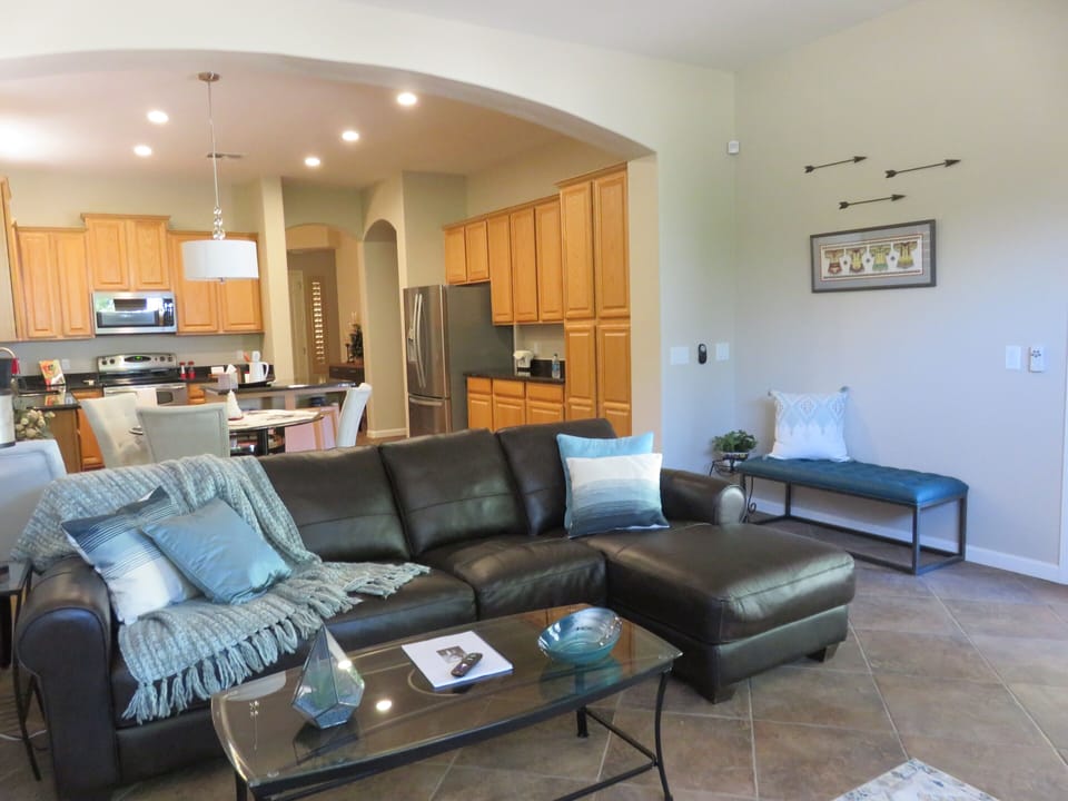 View of kitchen from leather sofa in family room.