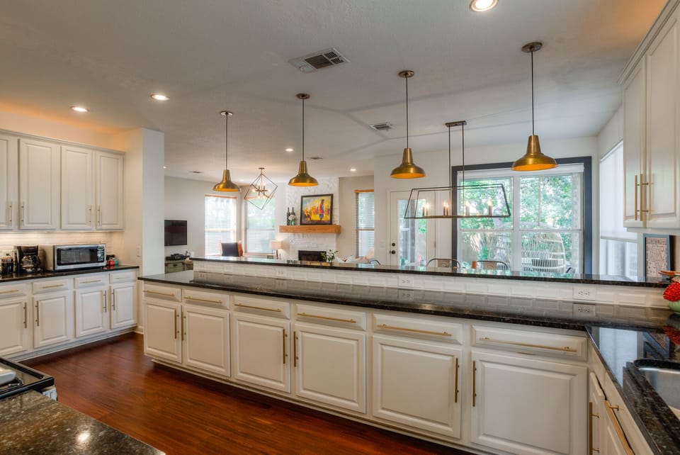 Spacious kitchen with all the appliances and some condiments for use.