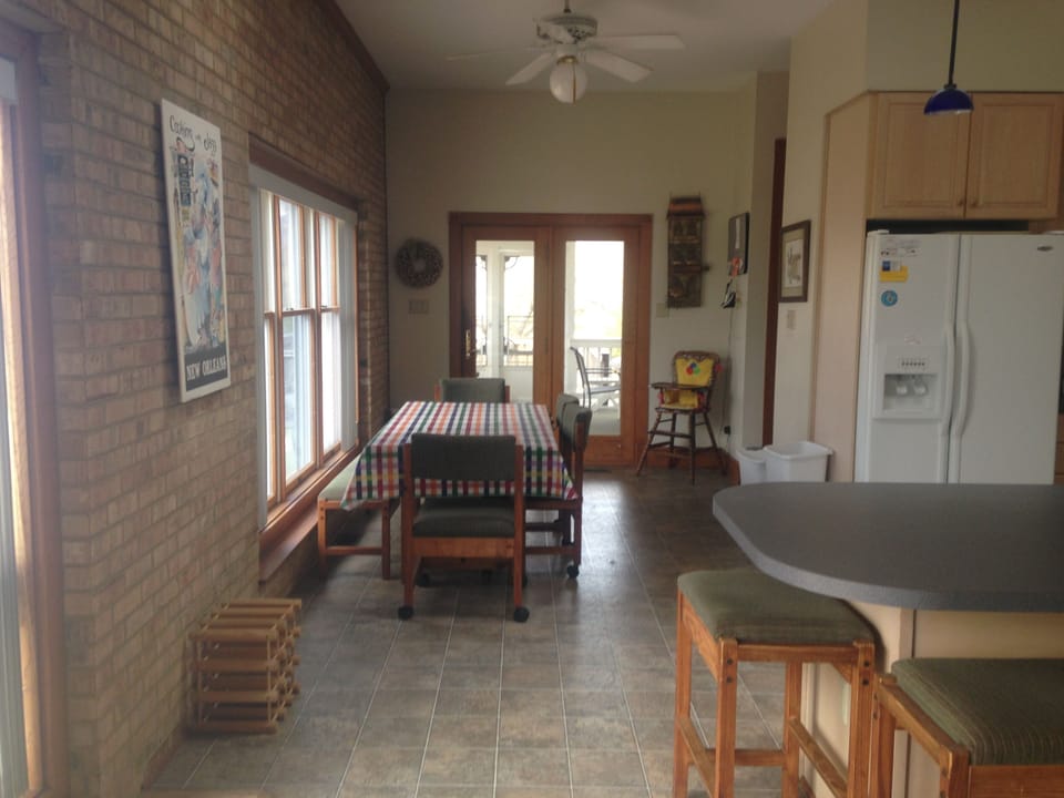 Eating area in kitchen directly off screen in porch