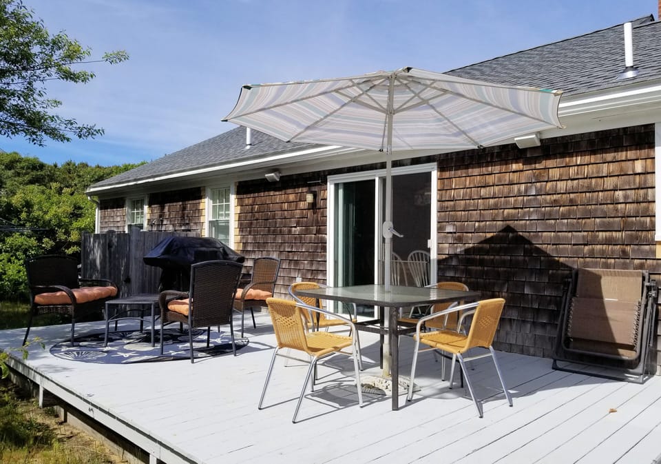 Outdoor furniture and gas grill on deck