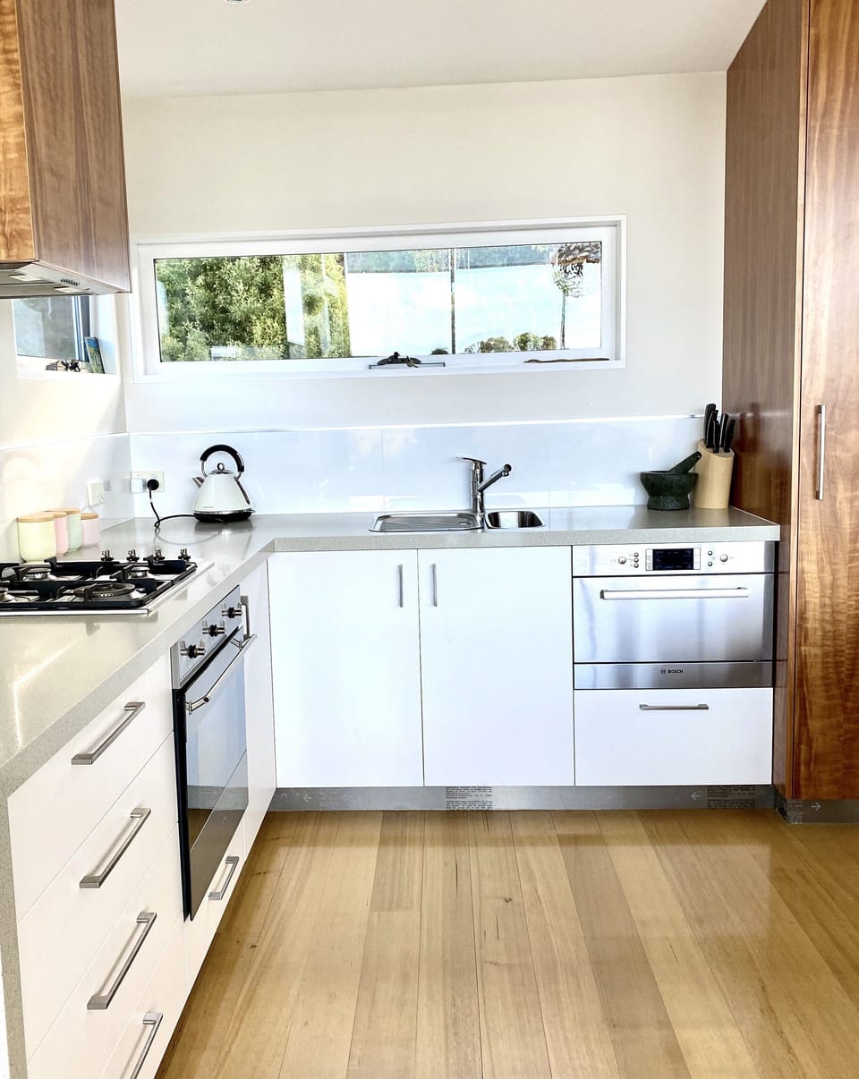 kitchen with oven, cooktop and dishwasher.