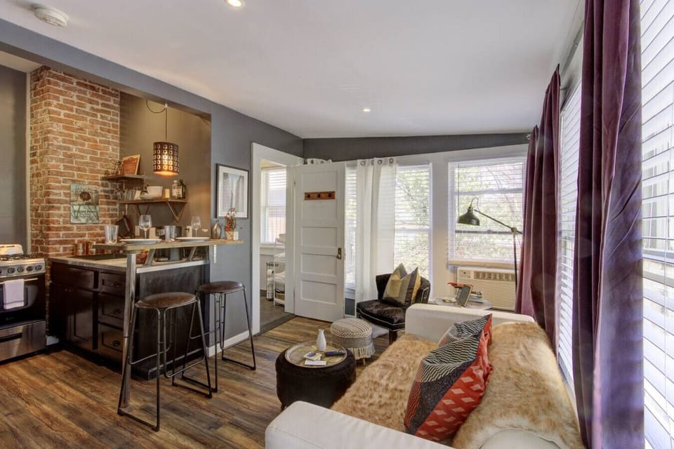 Unwind in the living area featuring an open kitchen layout, with plenty of cozy spots to lounge and recharge.