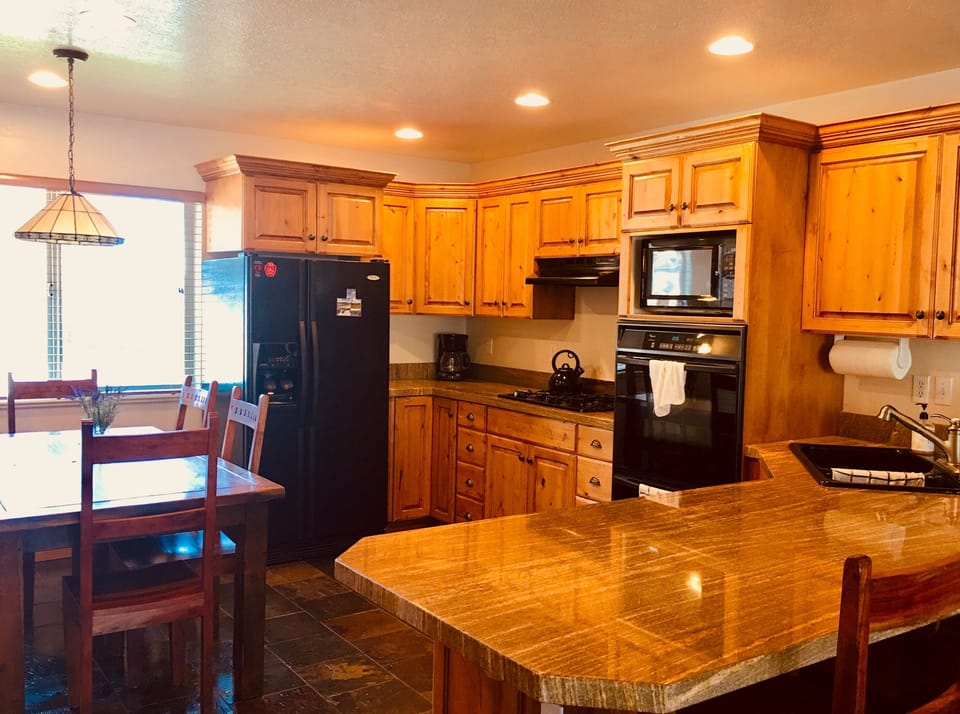 Full kitchen w/ gas range, double oven, dishwasher, full size fridge.