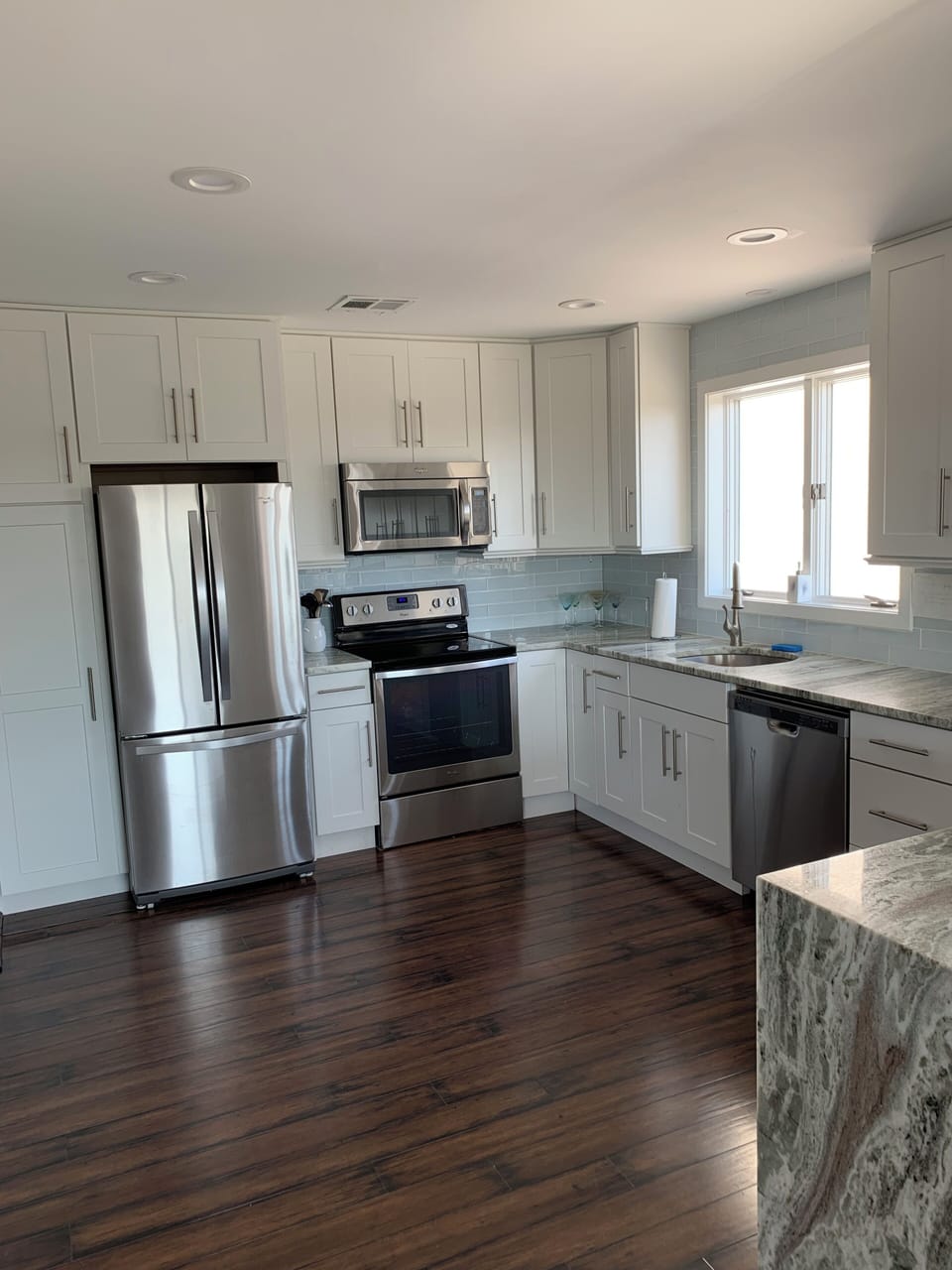 Kitchen with refrigerator, stove, oven, microwave, dishwasher. 