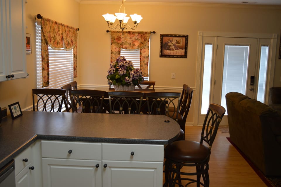 Bar in Kitchen looking into Dining Area with Kitchen Table and chairs