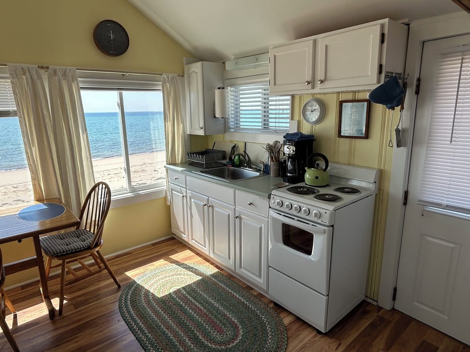 New electric stove, microwave, blender, pot & pans and flatware.