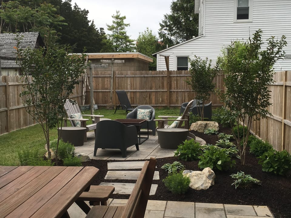 Backyard patio with dining table and lounge chairs