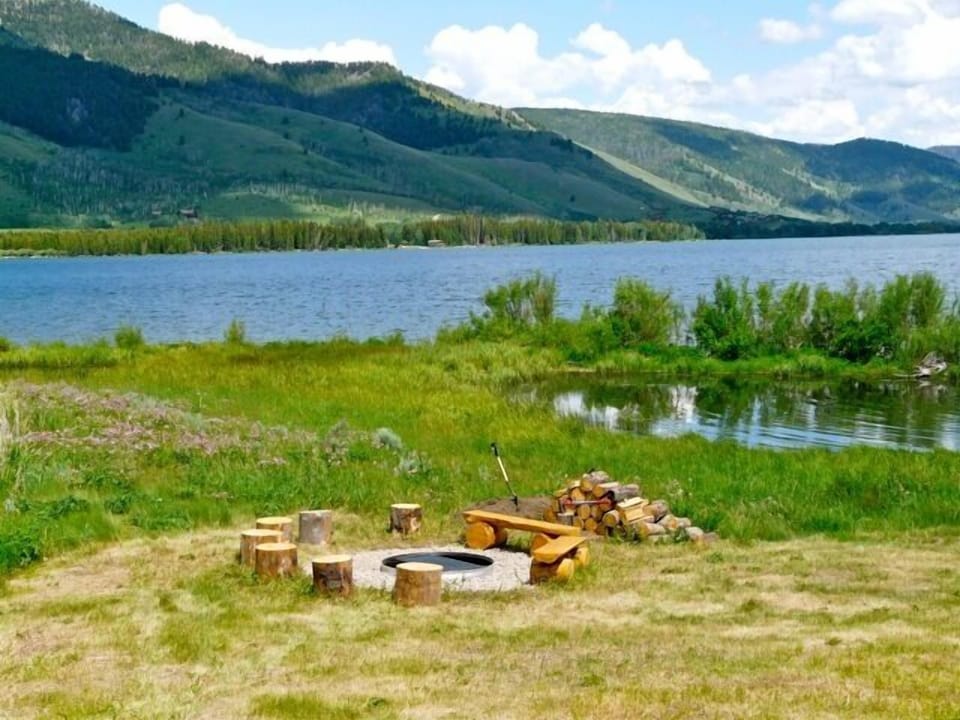 Lakeside fire pit with seating for 11 with  hotdog skewers, wood, lighter fluid.