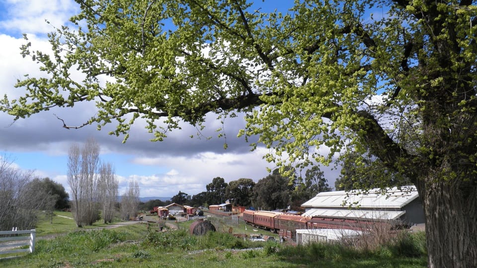 Spring view of railway station across the road. Listen for the whistle beat