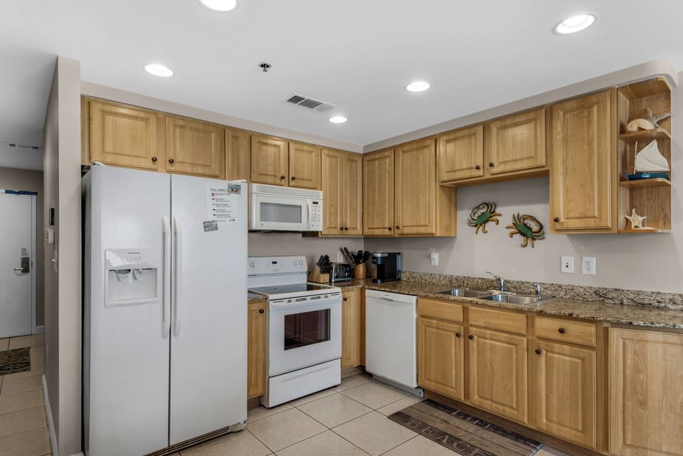Fully stocked kitchen to include dishware, glassware, pots and pans