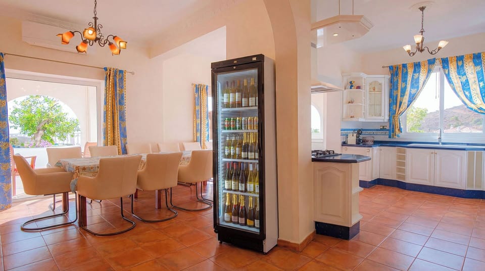 Family dining table for 14 guests alongside the villa’s fully equipped kitchen.