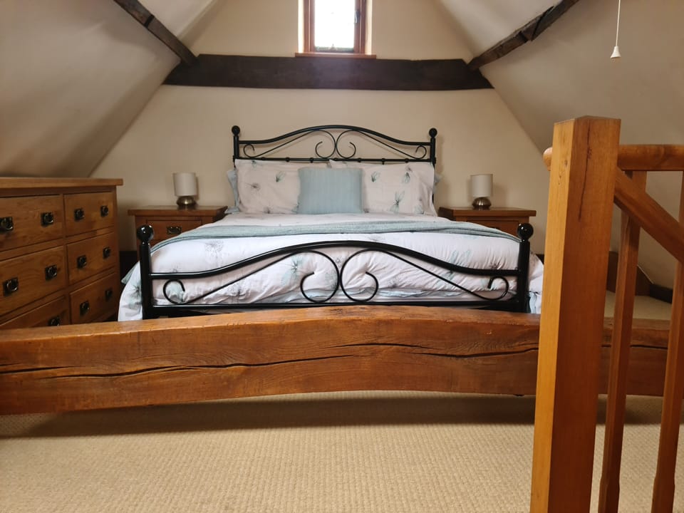 The beam is 38cm in the middle & 34cm at the sides of the bed