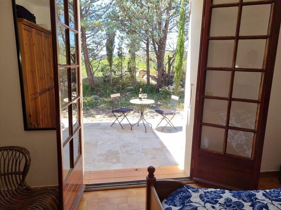 View from the master bedroom out onto the small patio at the back of the house