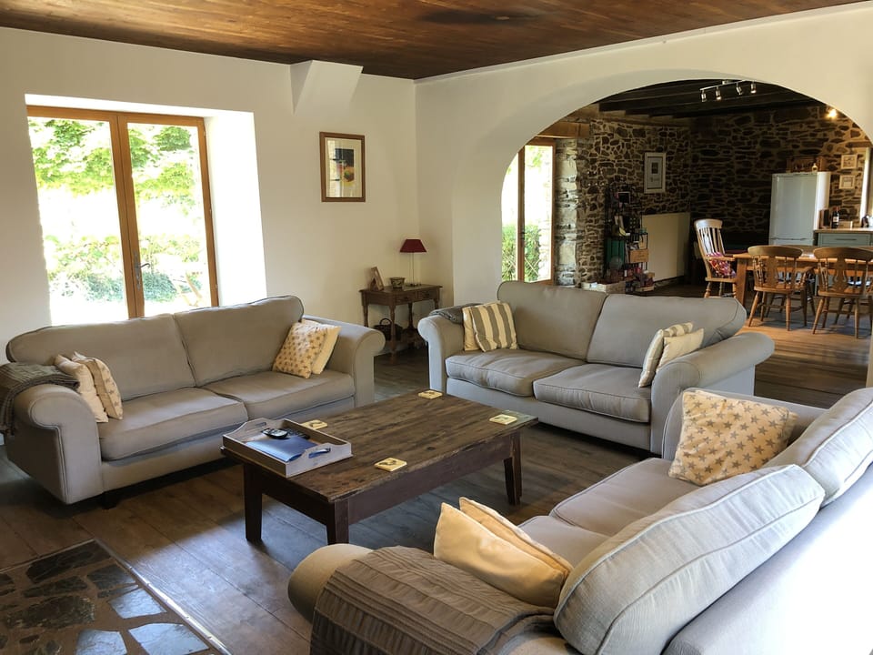 Sitting room.  Three x three seater sofas.  French doors to rear terrace.