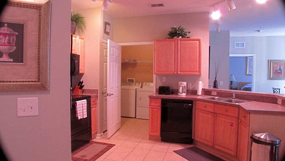 Kitchen area with laundry room behind it
