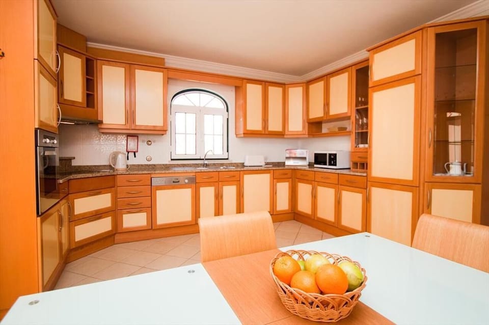 Kitchen with exits to Balcony & BBQ, Living room, and hallway/stairs.