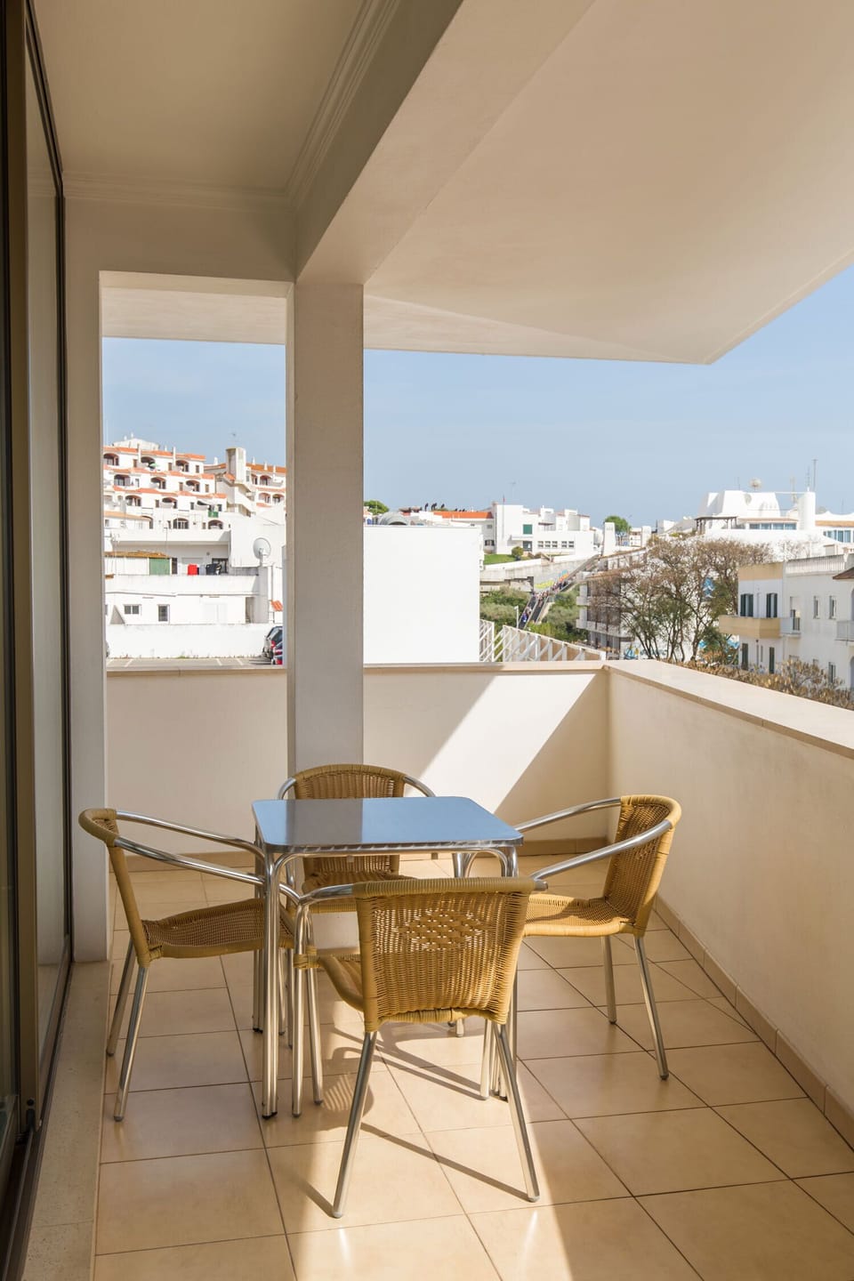 South facing private balcony with table and chairs under shade