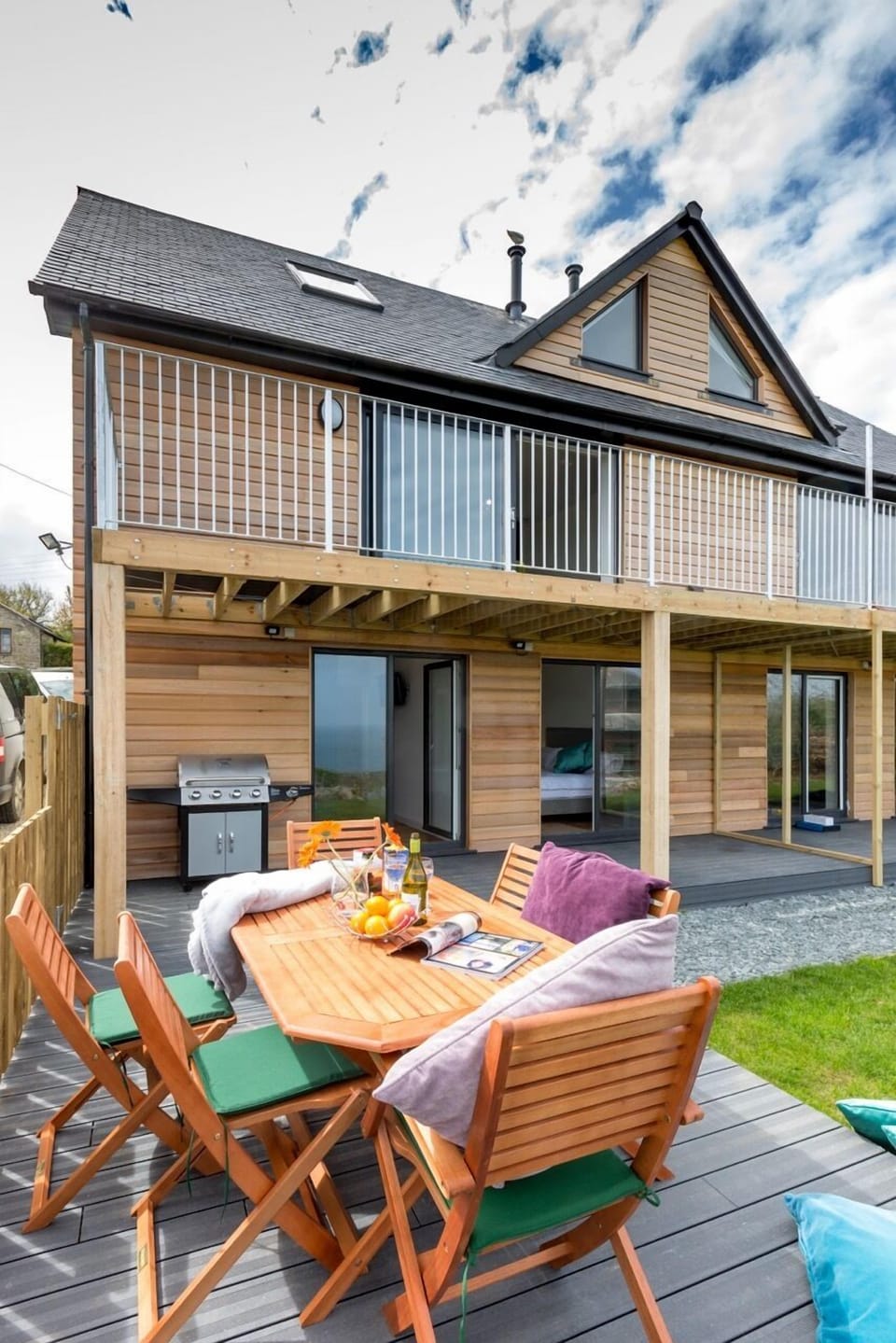 Decking below with BBQ & Balcony above.  Sliding doors to lounge.