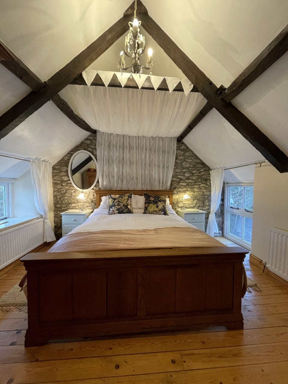 Master bedroom, with king sized bed canopied under original beams
