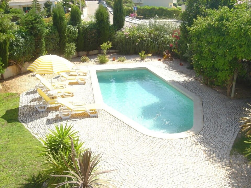 view of pool and garden from villa balcony